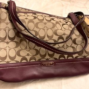 Coach monogram handbag with burgundy leather trim